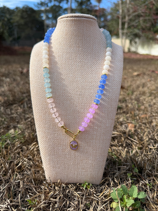 Colorful beaded necklace on a mannequin bust with a natural background