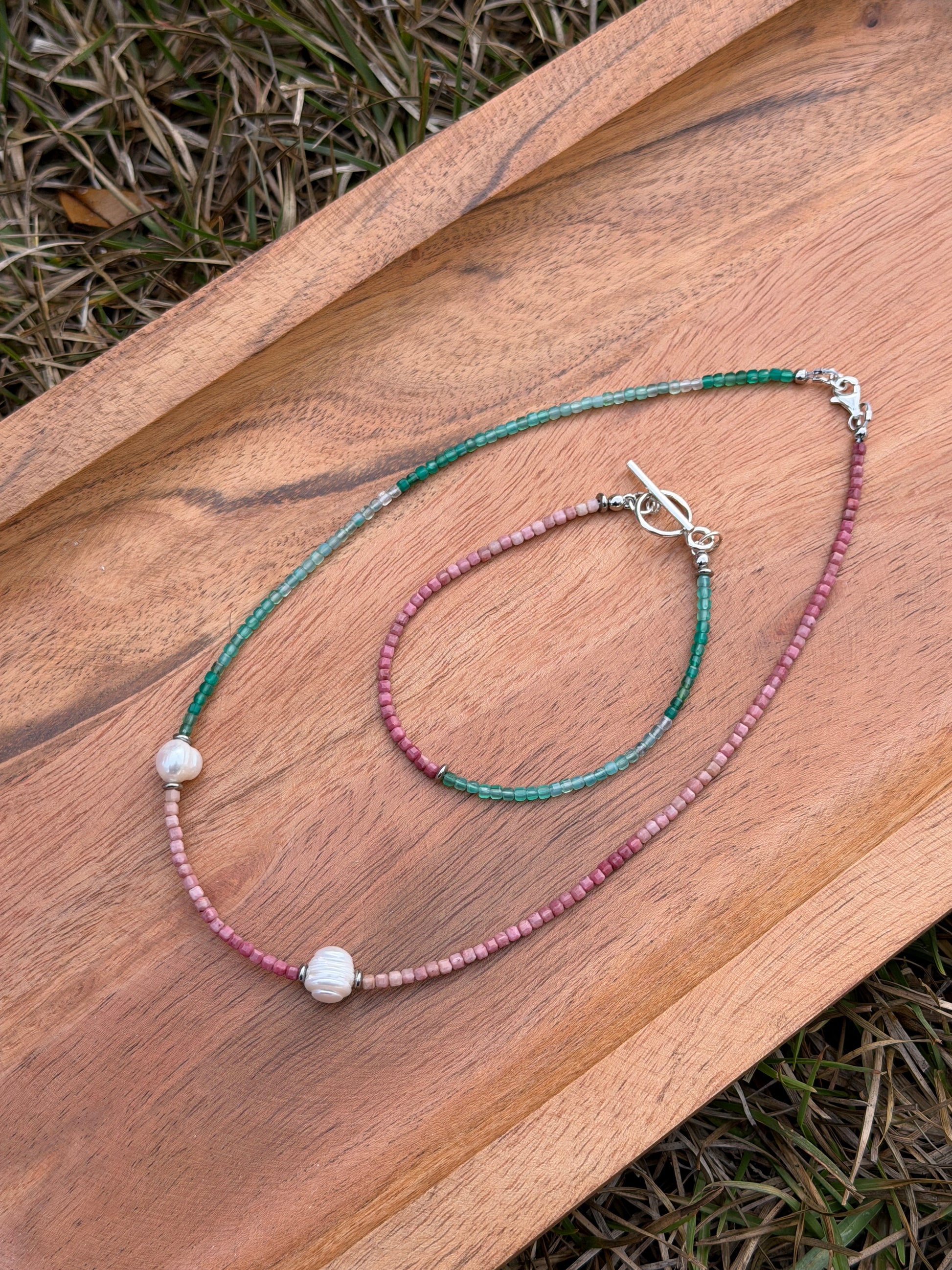 Necklace with beads and a clasp on a wooden surface