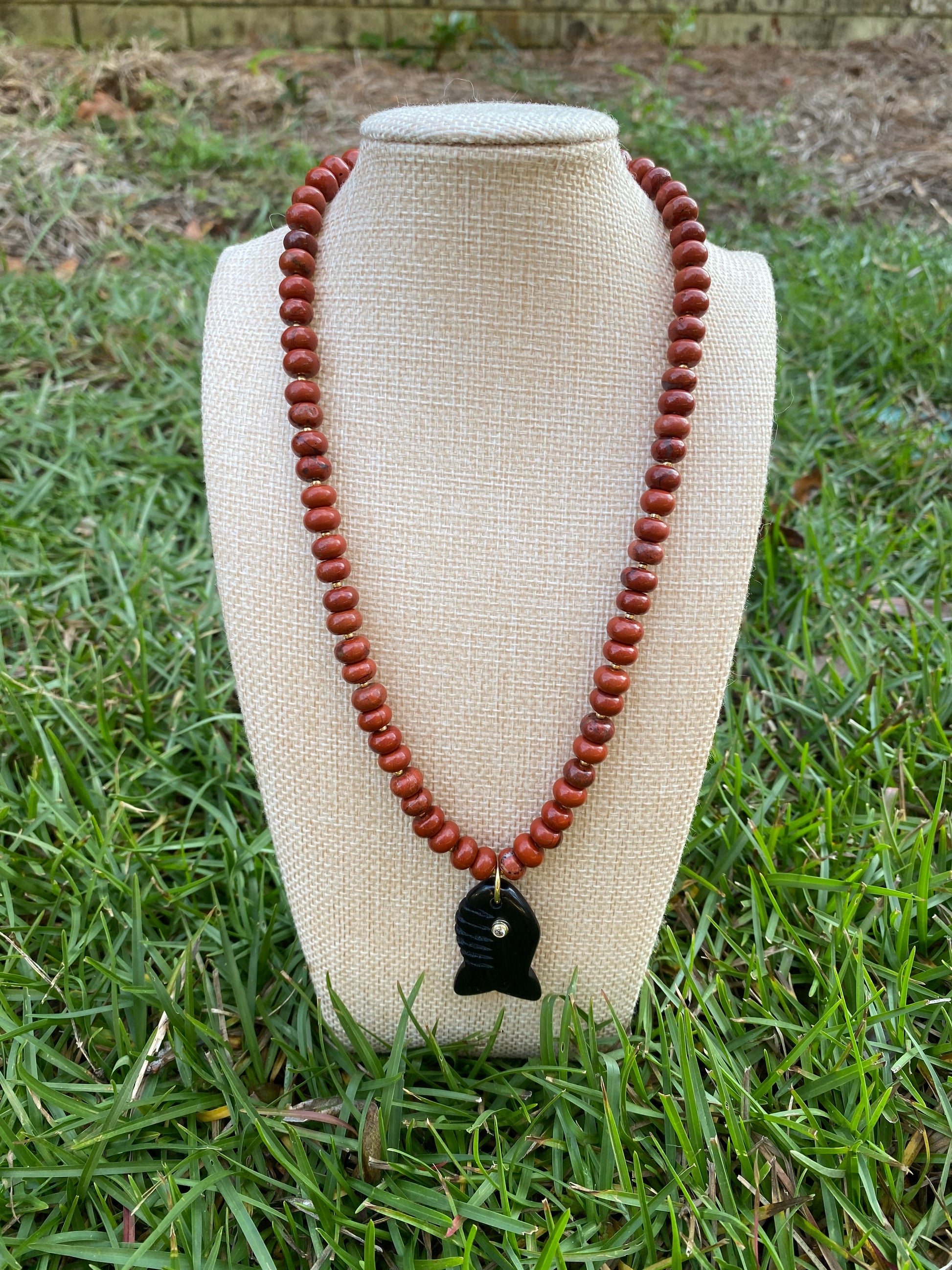 Natural red jasper bead with black fish charm